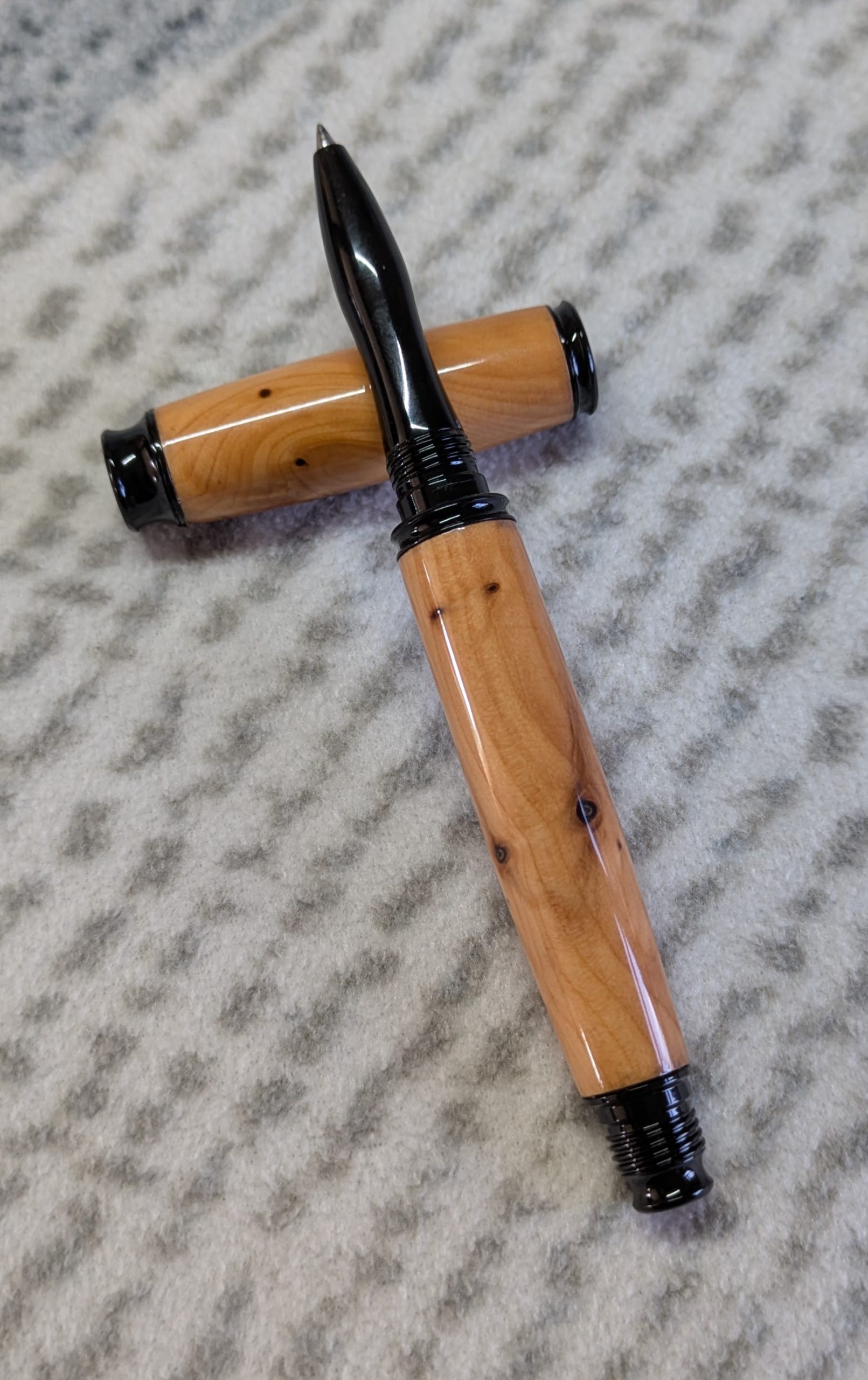 Omega style wooden rollerball made from yew with black fittings