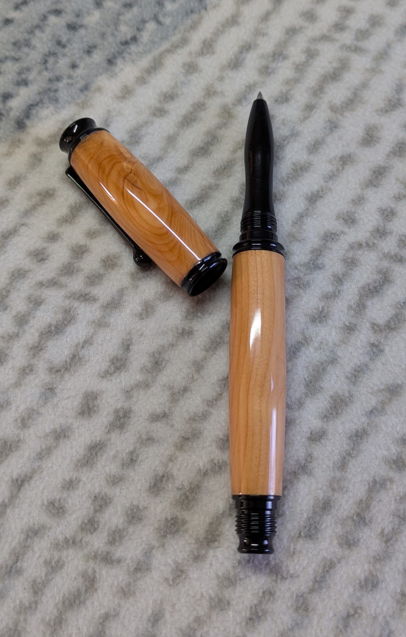 Omega style wooden rollerball made from yew with black fittings