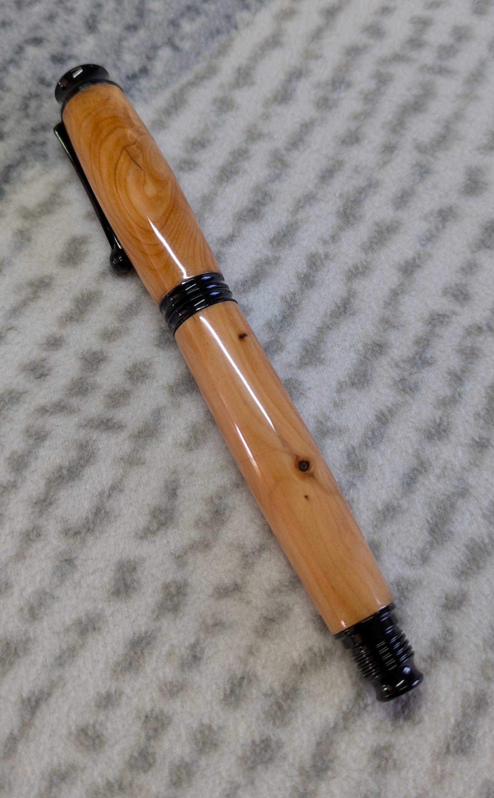 Omega style wooden rollerball made from yew with black fittings