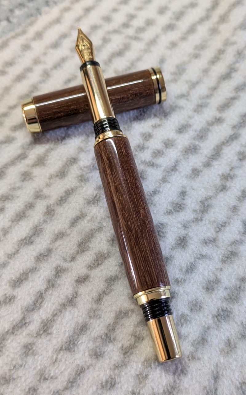 Wooden fountain pen made from gombeira wood with gold coloured fittings