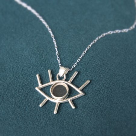 An eye-shaped pendant on a silver chain. The pendant is made from sterling silver and smokey quartz.
