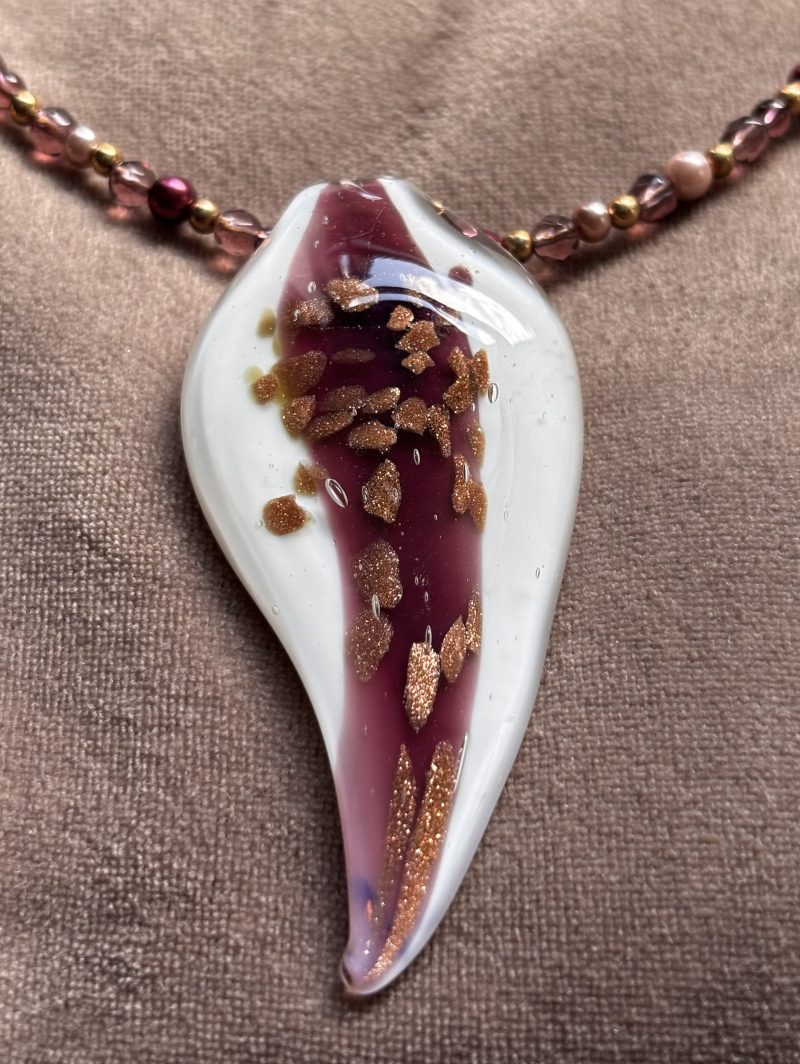 White and Burgundy resin pendant on a beaded necklace