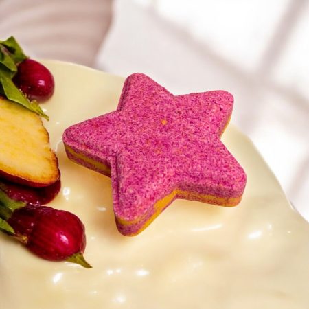 A pink and yellow star shaped bath bomb