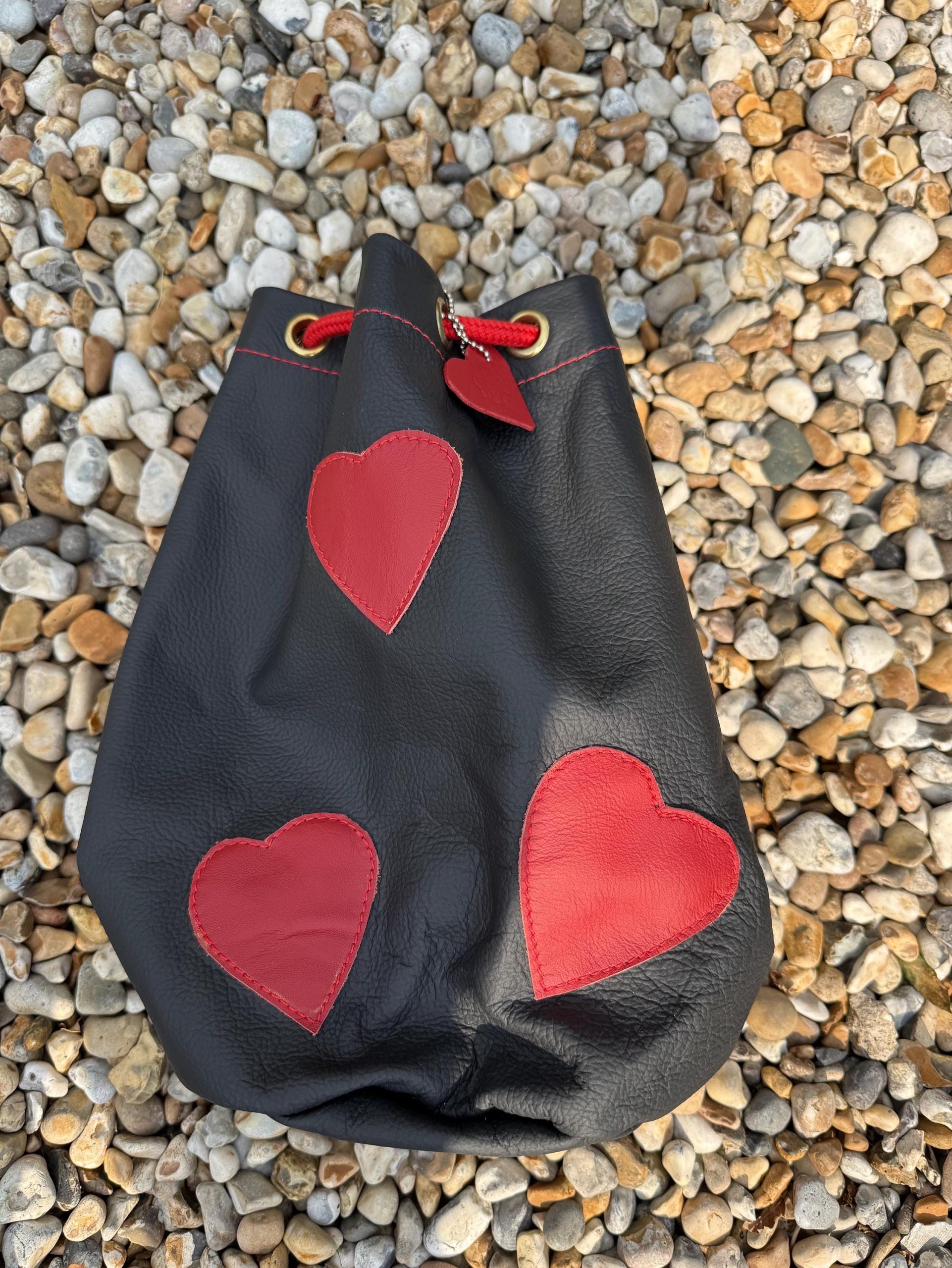 Black leather love heart drawstring duffel shoulder bag