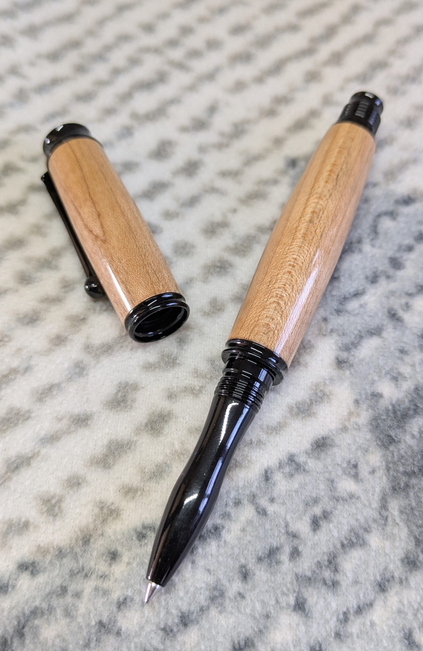 Omega style wooden rollerball made from maple with black fittings