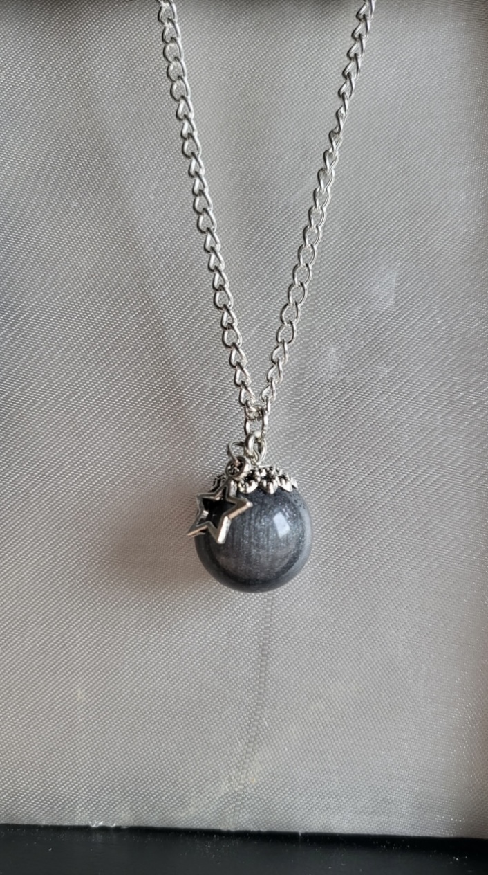 Silver moon themed resin ball necklace