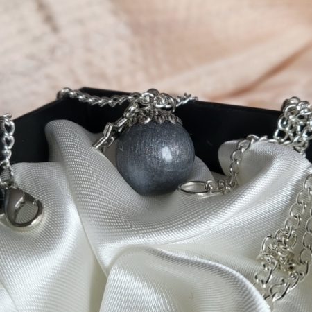 Silver moon themed resin ball necklace