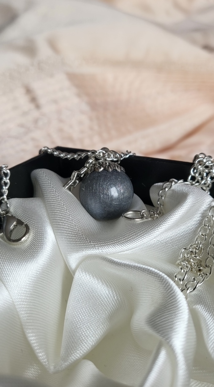 Silver moon themed resin ball necklace