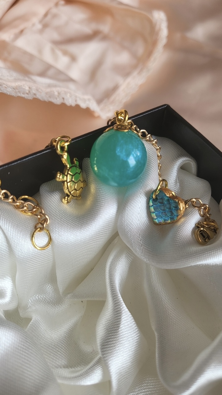 Shimmering aqua mermaid themed resin ball bracelet