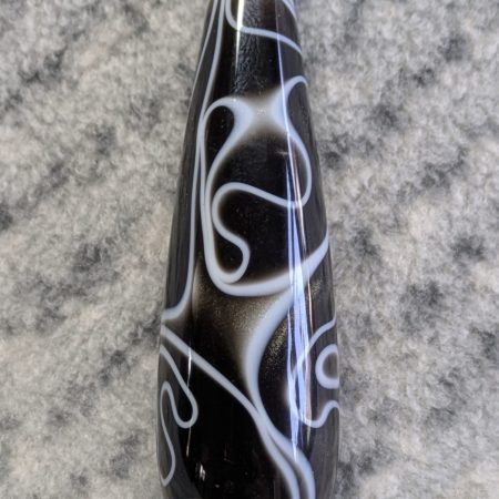 Light switch pull pendant made from black acrylic with white swirls and chrome fittings
