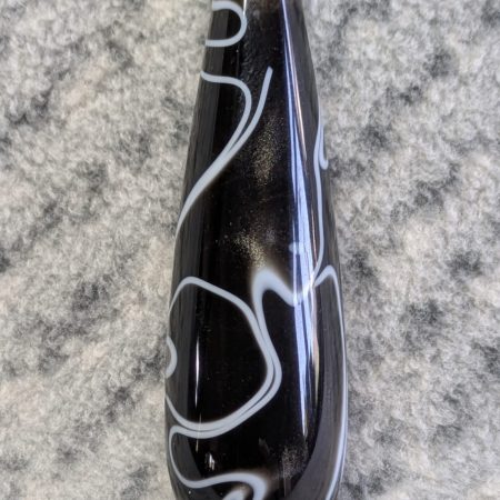 Light switch pull pendant made from black acrylic with white swirls and chrome fittings