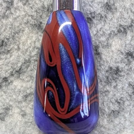 Light switch pull pendant made from blue acrylic with red swirls and chrome fittings