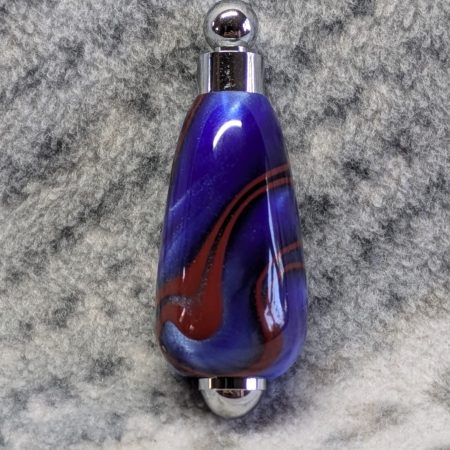 Light switch pull pendant made from blue acrylic with red swirls and chrome fittings