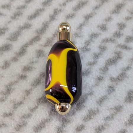 Light switch pull pendant made from Plum coloured acrylic with yellow lines