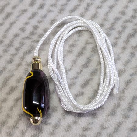 Light switch pull pendant made from Plum coloured acrylic with yellow lines