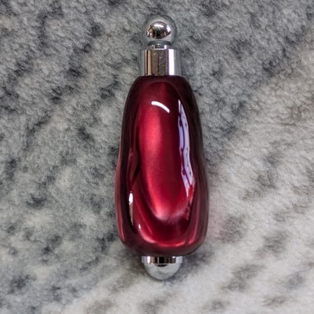 Light switch pull pendant made from shimmering red acrylic and chrome fittings