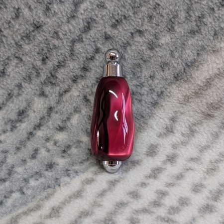 Light switch pull pendant made from shimmering red acrylic