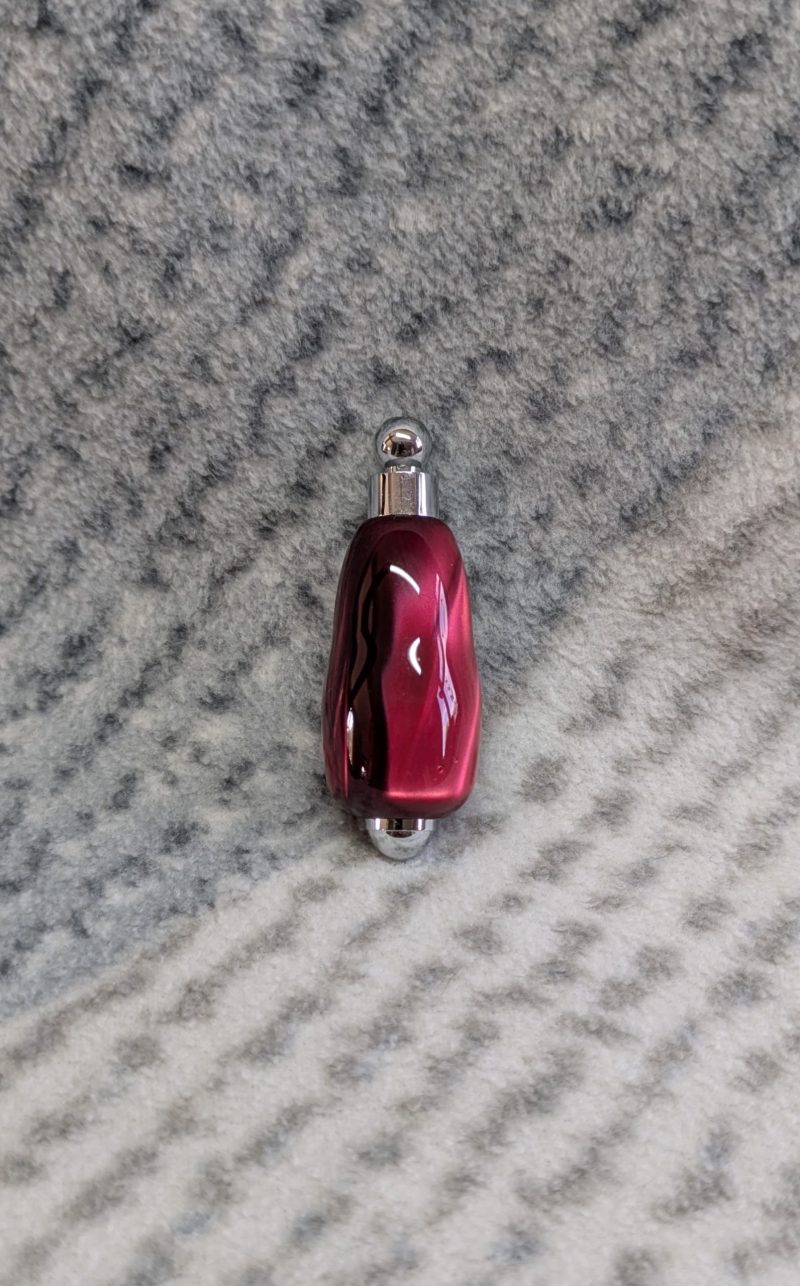 Light switch pull pendant made from shimmering red acrylic