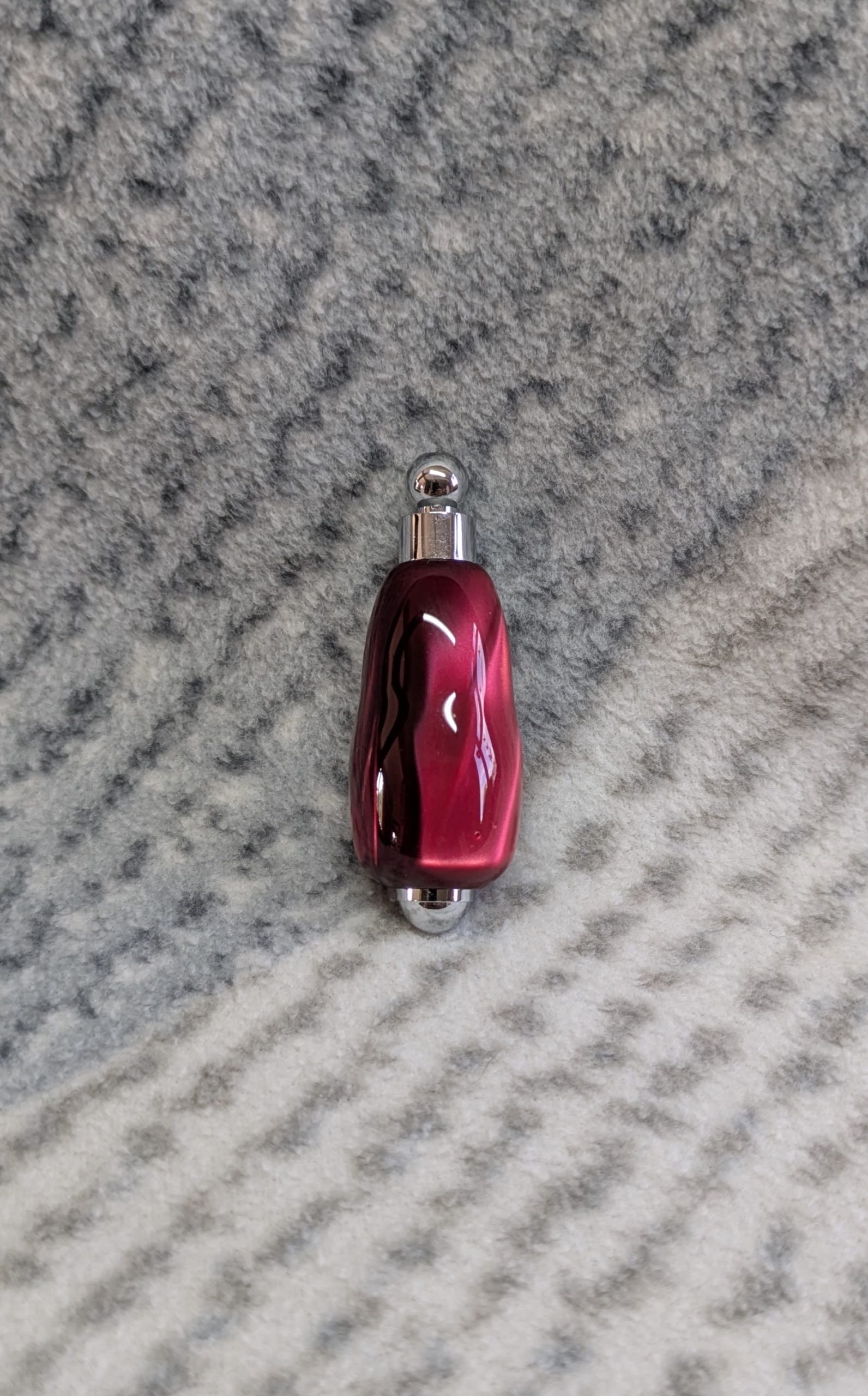Light switch pull pendant made from shimmering red acrylic