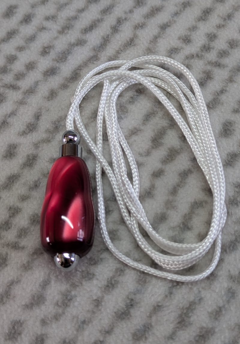 Light switch pull pendant made from shimmering red acrylic