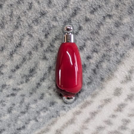 Light switch pull pendant made from shimmering red acrylic