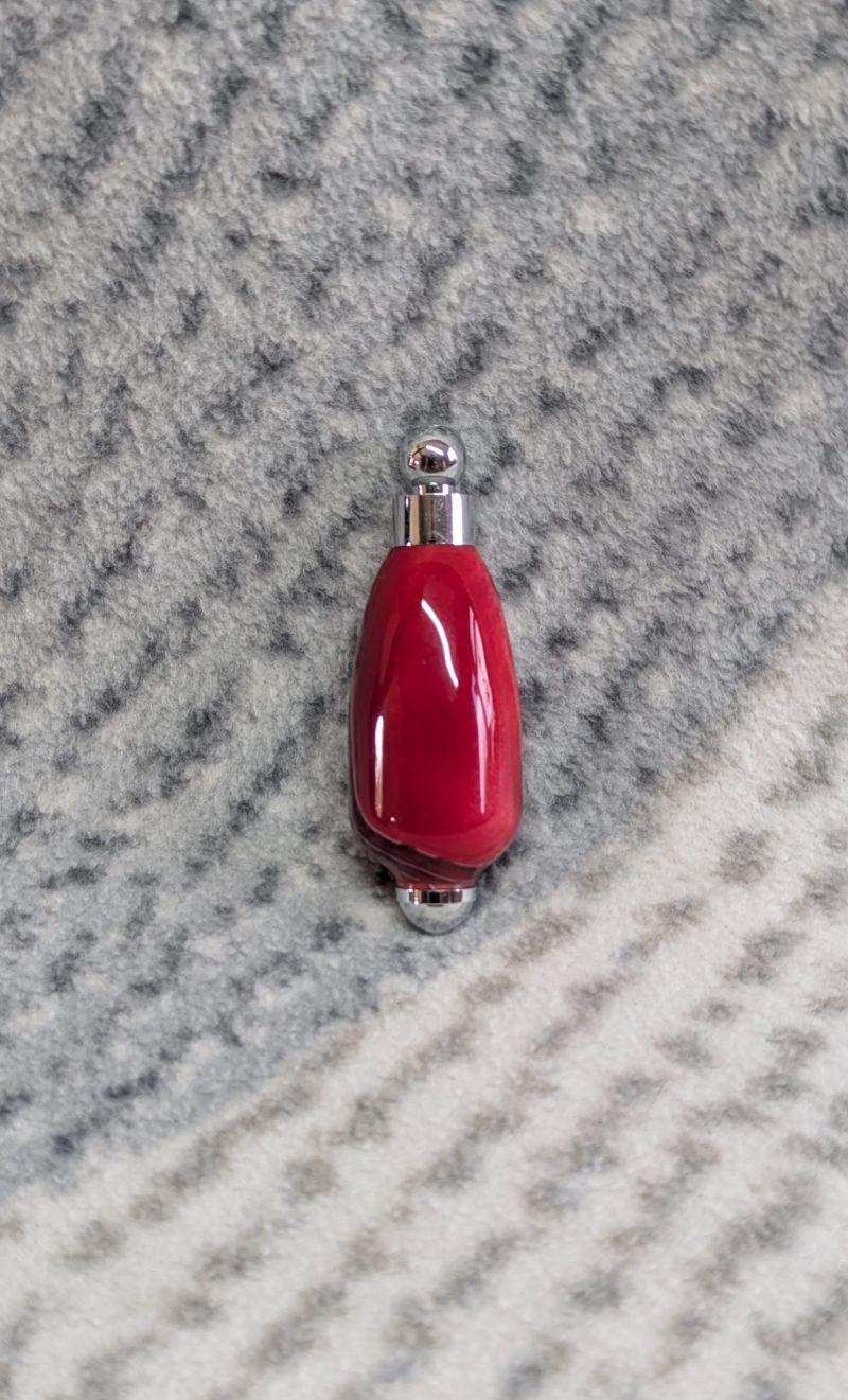 Light switch pull pendant made from shimmering red acrylic