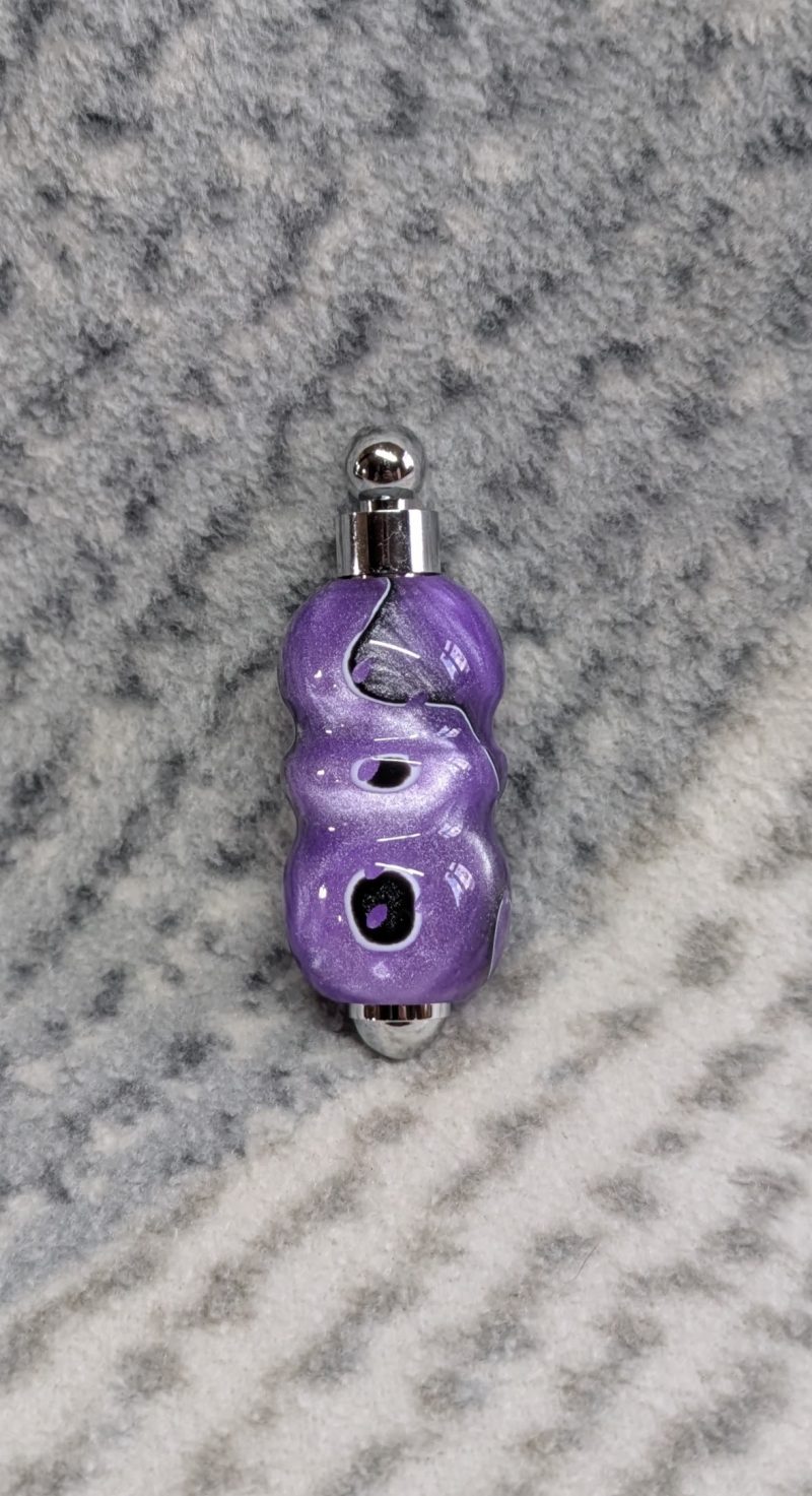 Light switch pull pendant made from shimmering purple acrylic