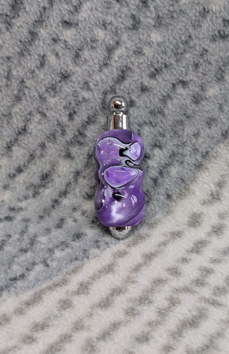 Light switch pull pendant made from shimmering purple acrylic