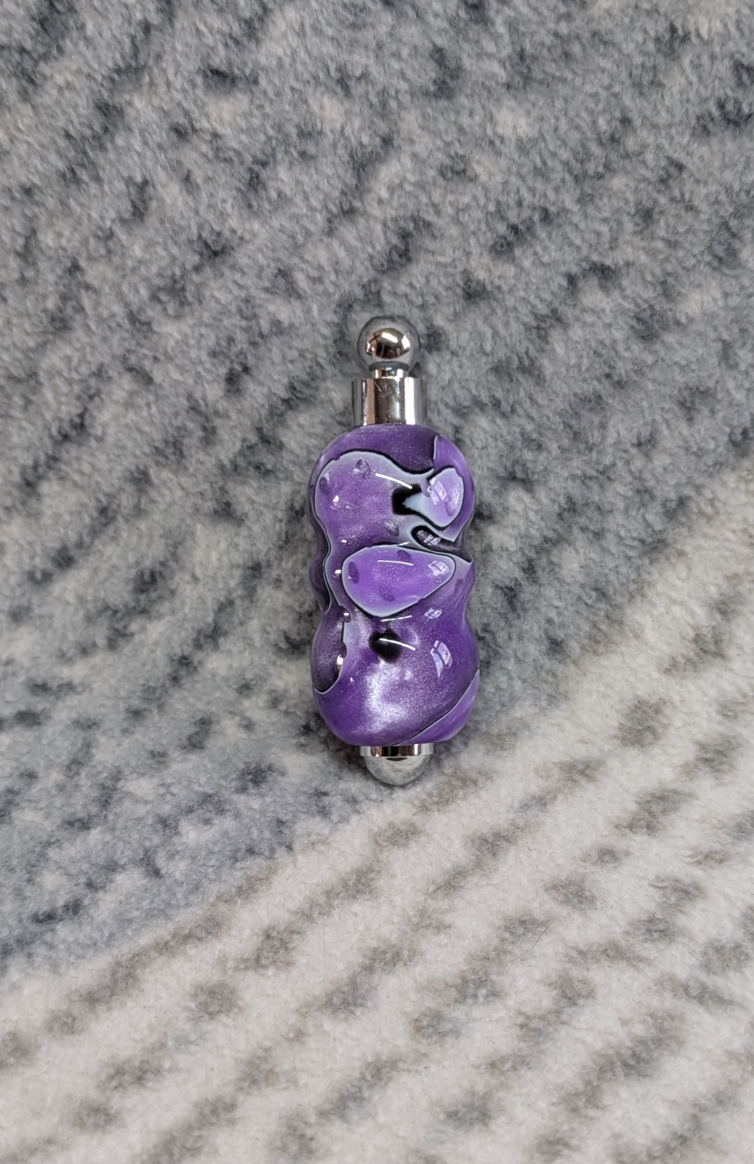 Light switch pull pendant made from shimmering purple acrylic