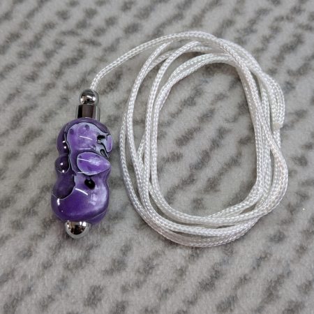 Light switch pull pendant made from shimmering purple acrylic