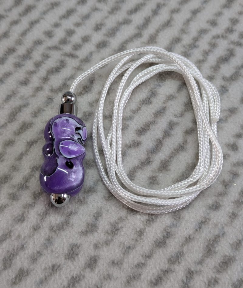 Light switch pull pendant made from shimmering purple acrylic