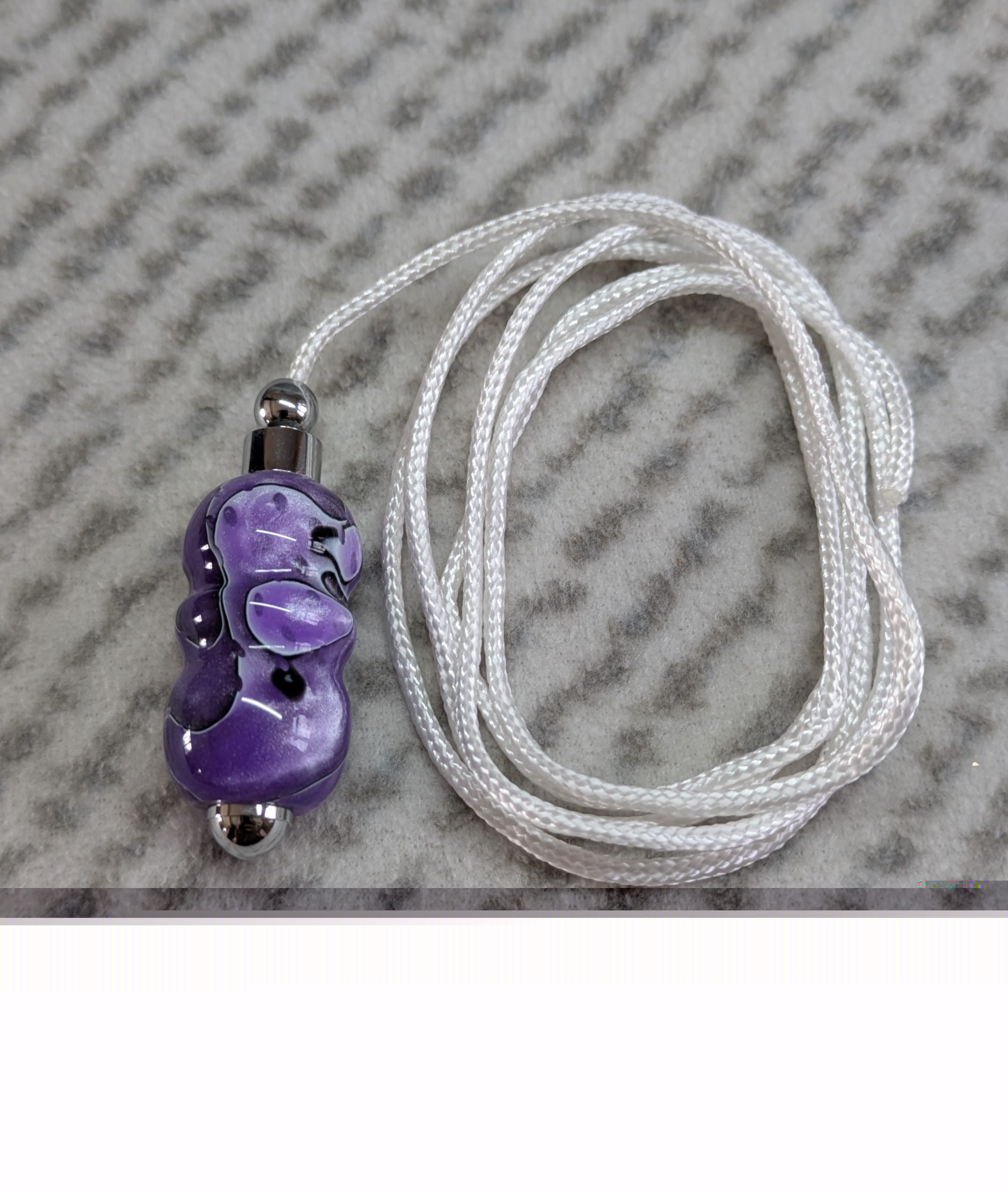 Light switch pull pendant made from shimmering purple acrylic