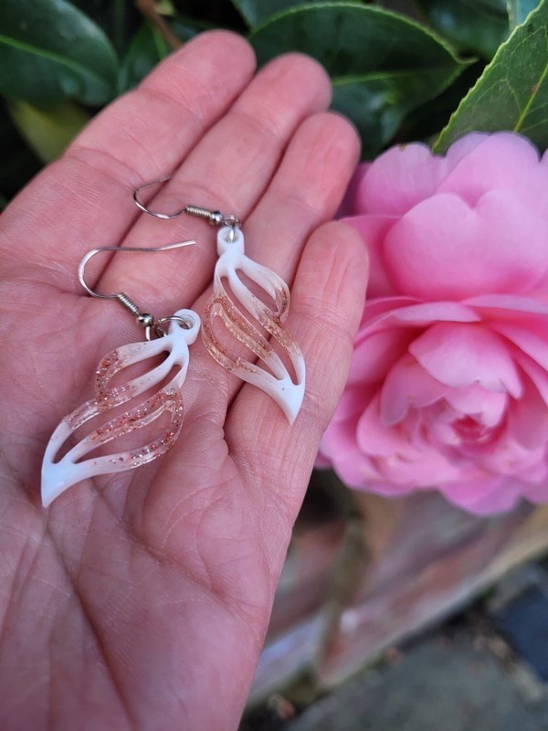 Resin earrings with white pigment and red glitter
