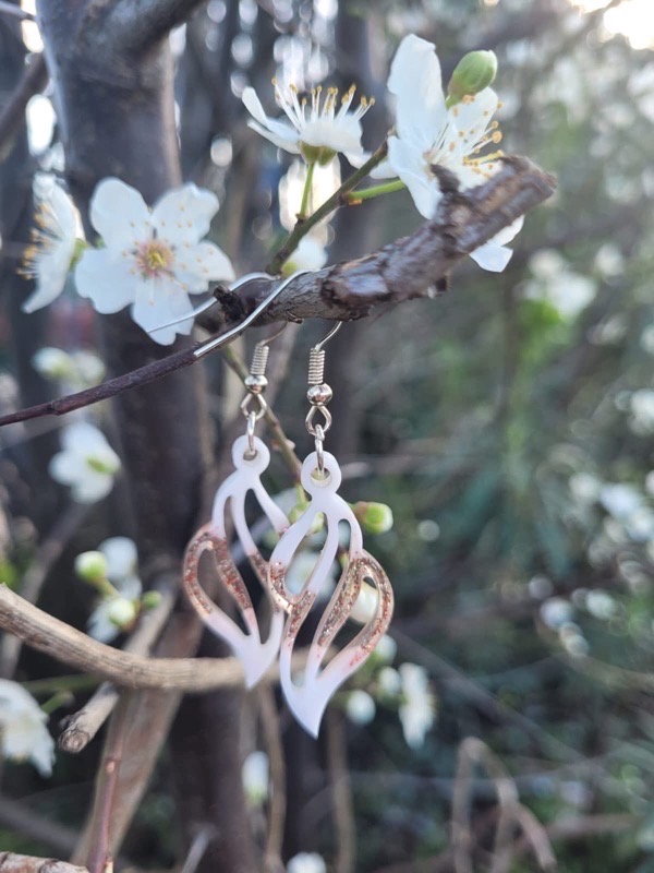 Resin earrings with white pigment and red glitter