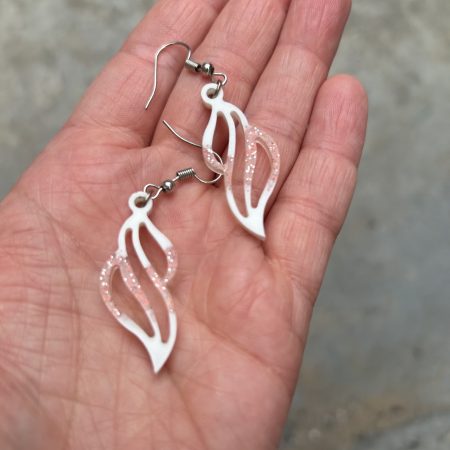 Resin earrings with white pigment and red glitter