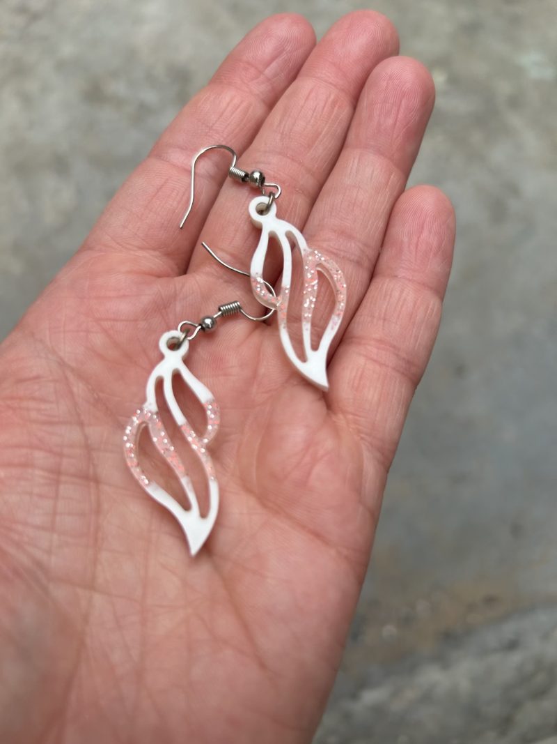 Resin earrings with white pigment and red glitter