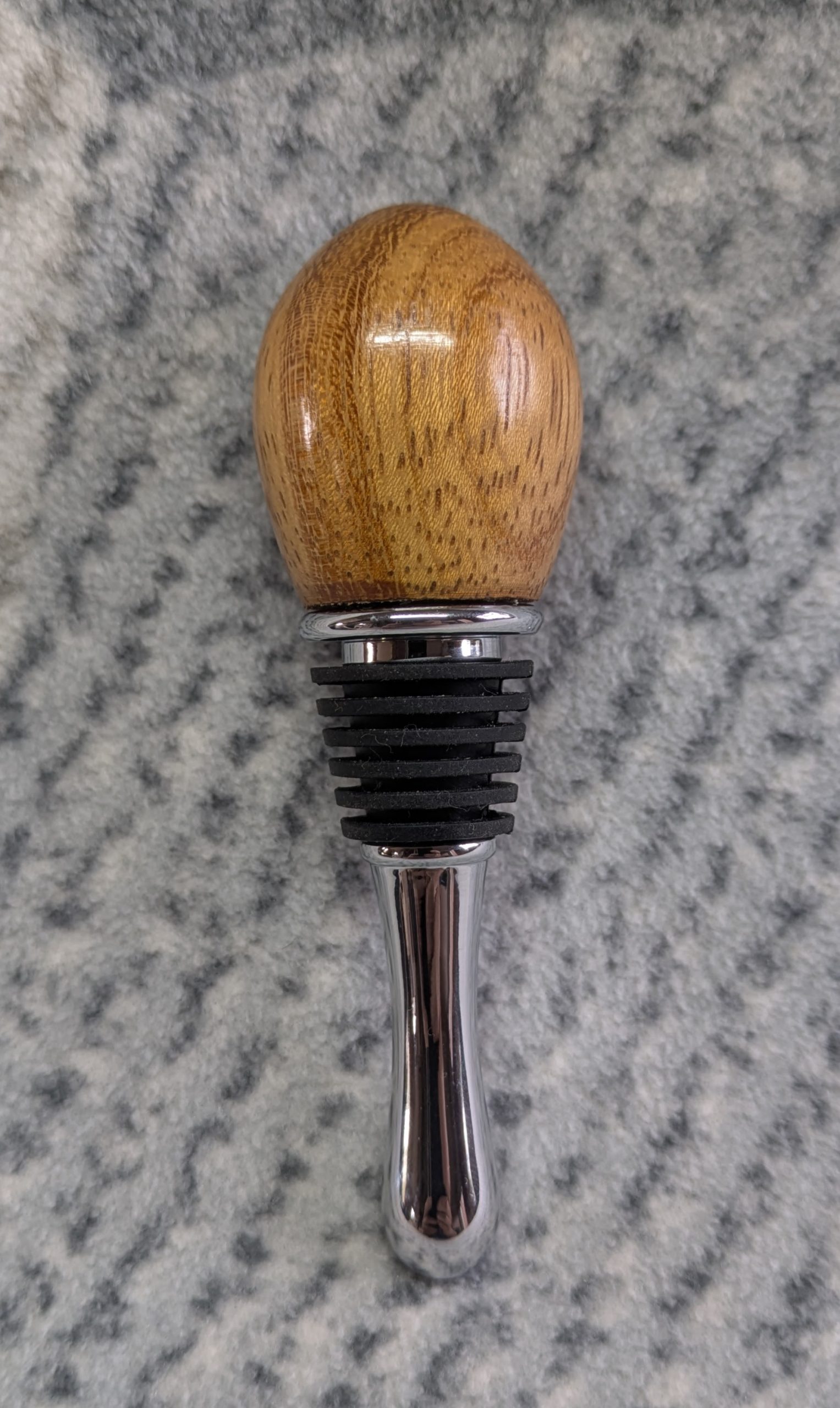 Hand turned bottle stopper made from iroko with a teardrop base