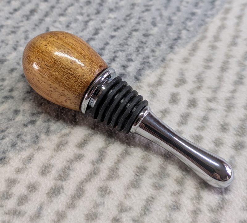 Hand turned bottle stopper made from iroko with a teardrop base