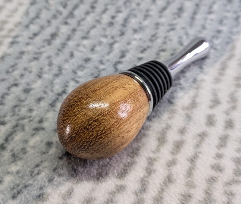 Hand turned bottle stopper made from iroko with a teardrop base