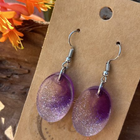 Resin oval earrings with silver glitter and touch if purple