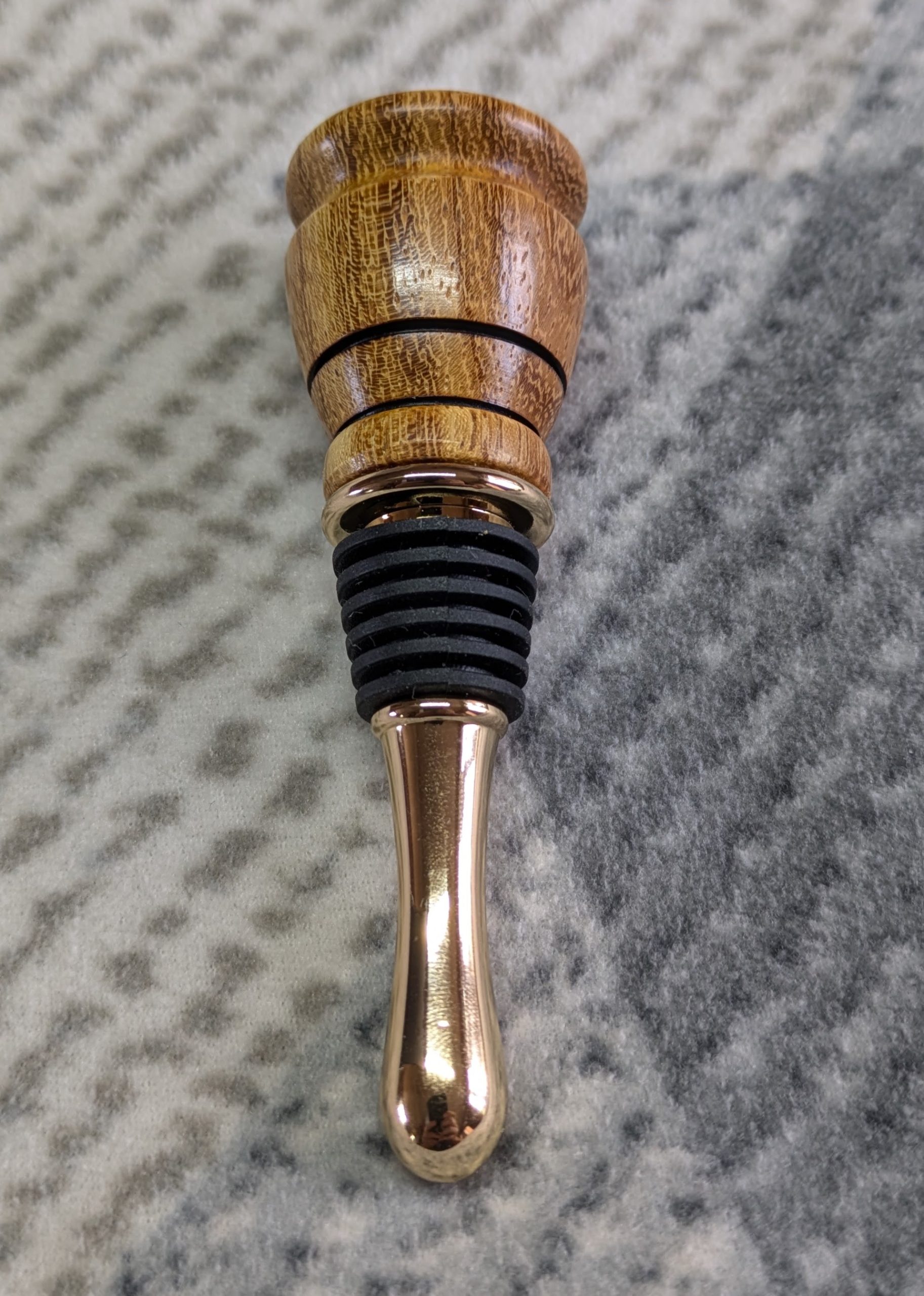 Hand turned bottle stopper made from iroko with a teardrop base