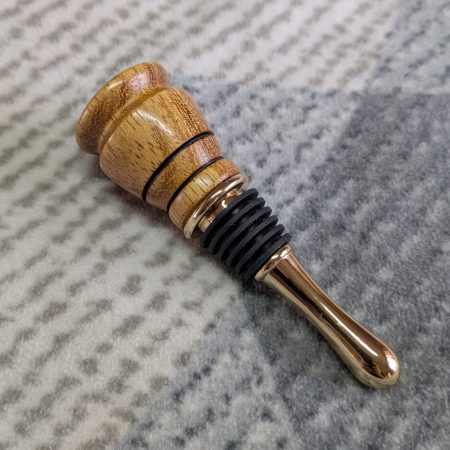 Hand turned bottle stopper made from iroko with a teardrop base