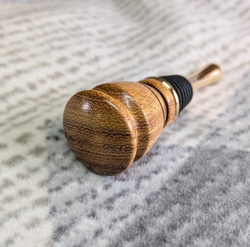 Hand turned bottle stopper made from iroko with a teardrop base