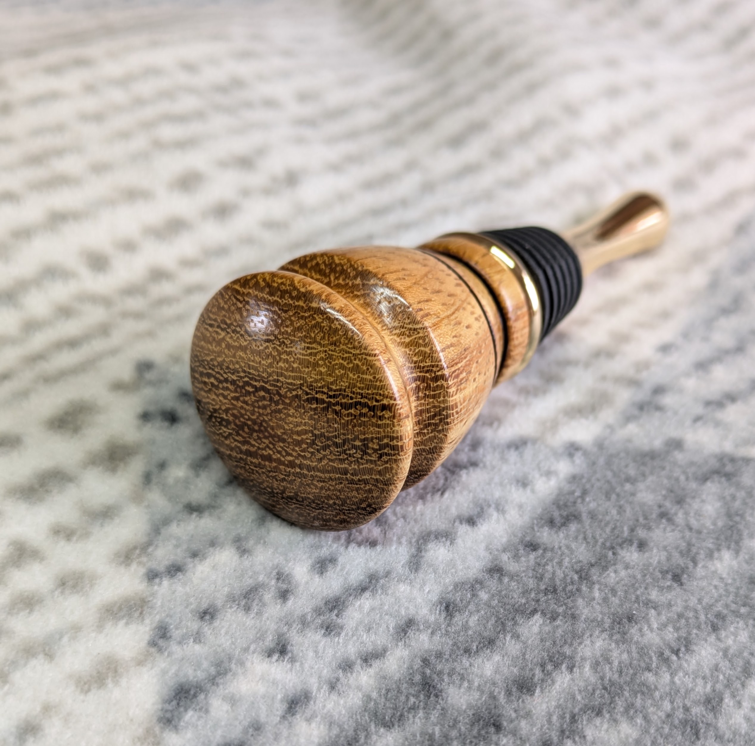 Hand turned bottle stopper made from iroko with a teardrop base