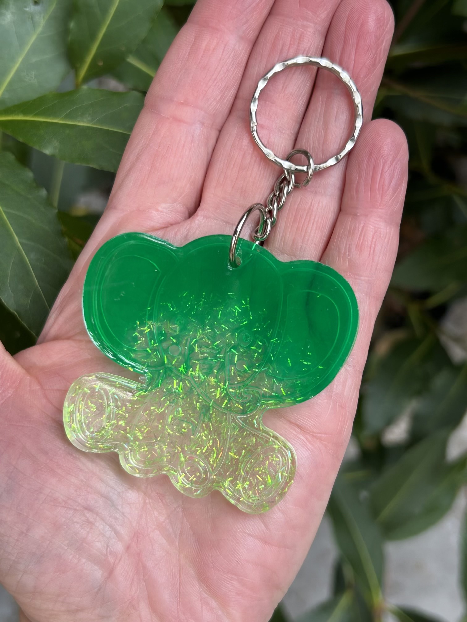 Resin lucky elephant keychain with green pigment and sparkly green glitter