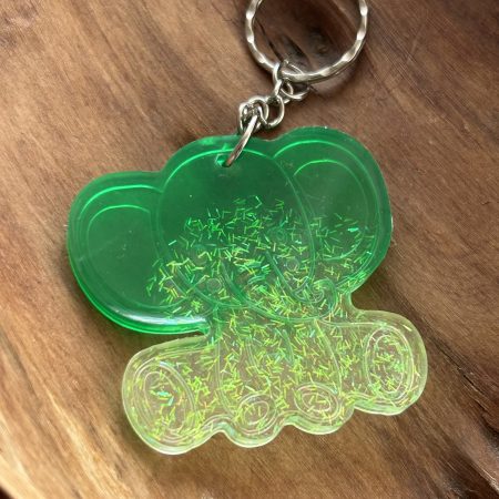 Resin lucky elephant keychain with green pigment and sparkly green glitter