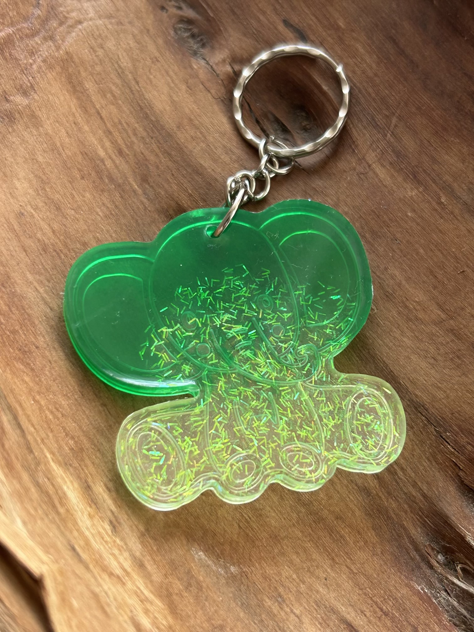 Resin lucky elephant keychain with green pigment and sparkly green glitter