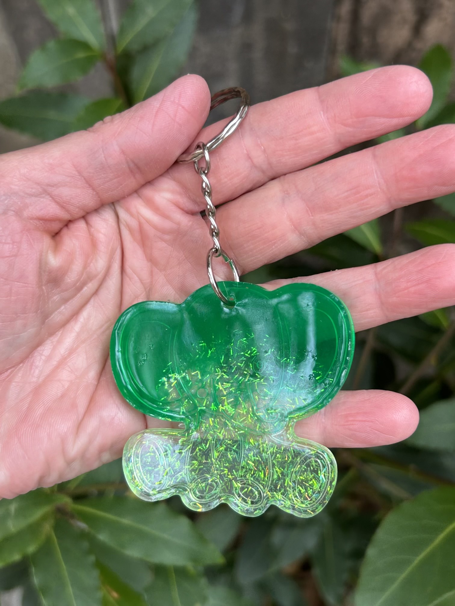 Resin lucky elephant keychain with green pigment and sparkly green glitter