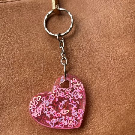 Resin heart shape keyring with small pink hearts and sparkly glitter
