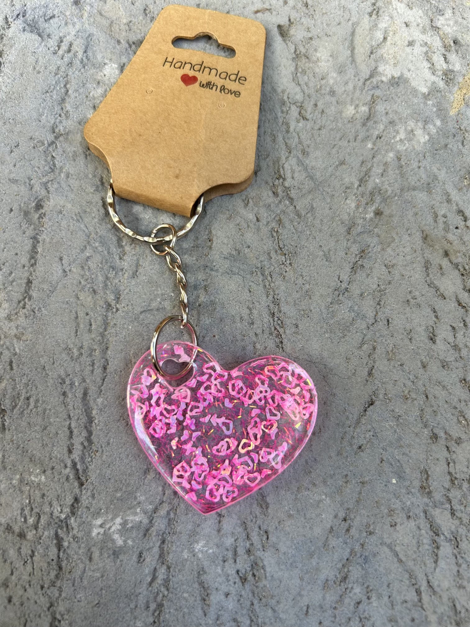 Resin heart shape keyring with small pink hearts and sparkly glitter
